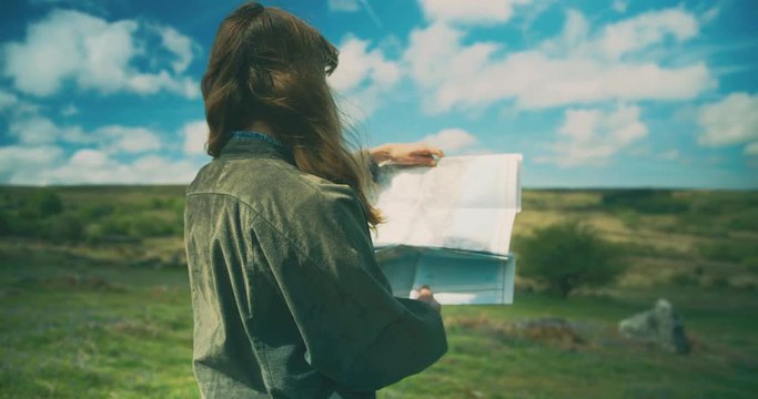 Young woman on moor studying map