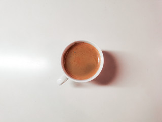black coffee in white cup on white marble table