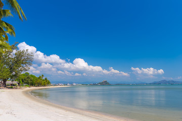 Coconut Palm trees on white sandy beach and  blue sky in south of Thailand