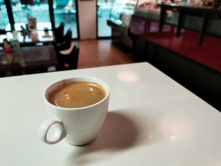 black coffee in white cup on white marble table