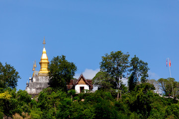 Fototapeta na wymiar Phusi Golden pagoda on the top of the mountain in Luang Prabang, in north central Laos 