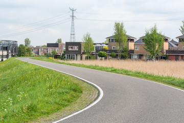 Fototapeta na wymiar Empty curved road on a dam in the dutch countryside, Capelle Aan Den Ijssel, Netherlands