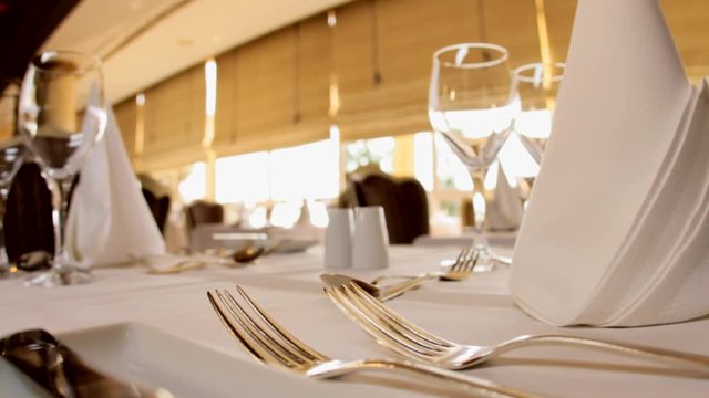 Slow zoom in on cutlery on a fancy restaurant.