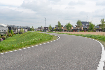Empty curved road on a dam in the dutch countryside, Capelle Aan Den Ijssel, Netherlands