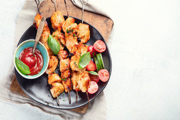 Grilled chicken on skewers. Top view with copy space