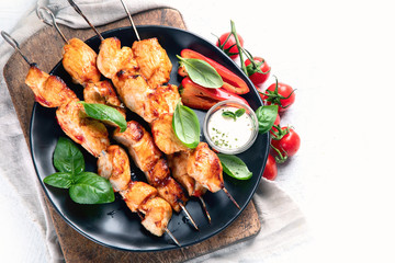 Grilled chicken on skewers. Top view with copy space
