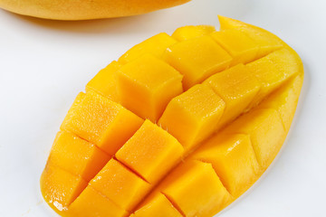 ripe yellow mango cut slice whole on white background