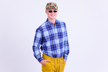 Fototapeta premium Happy young hipster man with sunglasses smiling