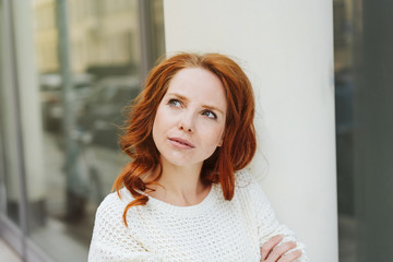 Fototapeta premium Young woman standing thinking deeply