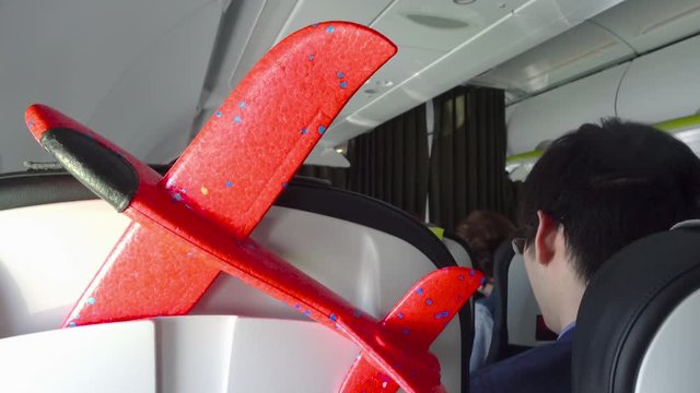 Being inside the plane with the child. Flying with a children's red paraglider