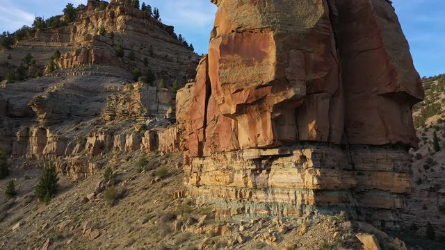 Flying along red rock cliffs in the Utah desert rising along the ridge in Nine Mile Canyon.
