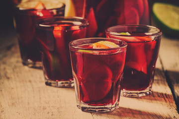 Sangria with red wine citrus and fruit on old wooden background, selective focus
