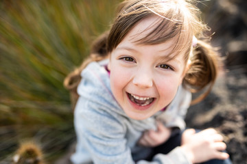 Headshot of cute little girl laughing