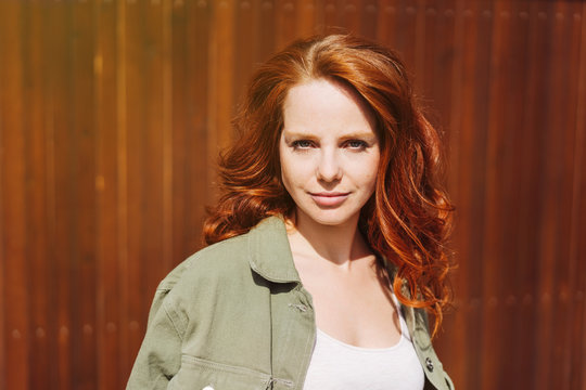 Serious intense young redhead woman