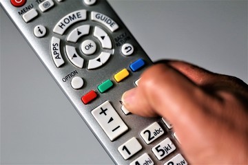 hand holding remote control isolated on white