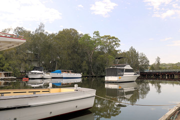 Fototapeta na wymiar Boats on Stoney Creek with Trees and Reflections