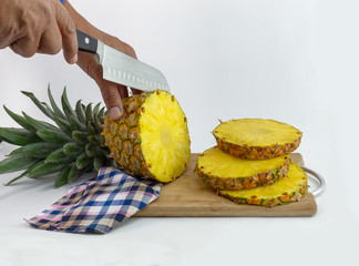 hands that cut a delicious pineapple
