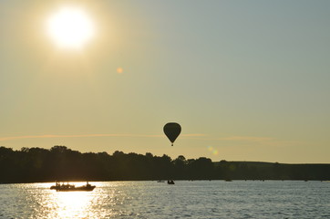 Hot air balloons over a lake in Poland view during sunset