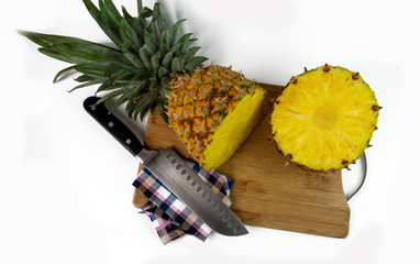 Aerial shot of a pineapple cut into slices on a chopping board