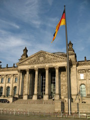 Obraz premium Reichstag building in Berlin, Germany and German flag in front