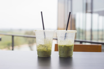 Plastic glasses of green tea. Cold beverages in summer. Refreshment at cafe shop