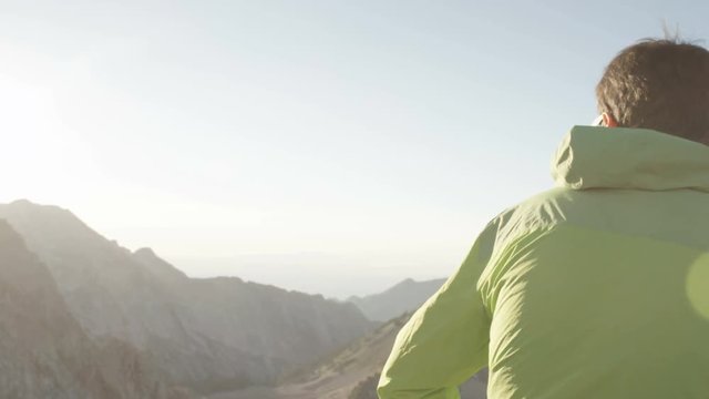 Camera pans around mans back and reveals view of beautiful Wasatch Front in Utah