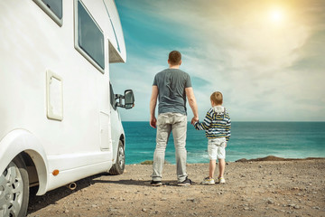 Happiness father and son, stay near them white travel car and lo