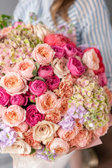 Large Beautiful bouquet of mixed flowers in woman hand. Floral shop concept . Beautiful fresh cut bouquet. Flowers delivery