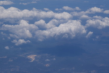 Fototapeta na wymiar Large white clouds in the blue sky, top view.