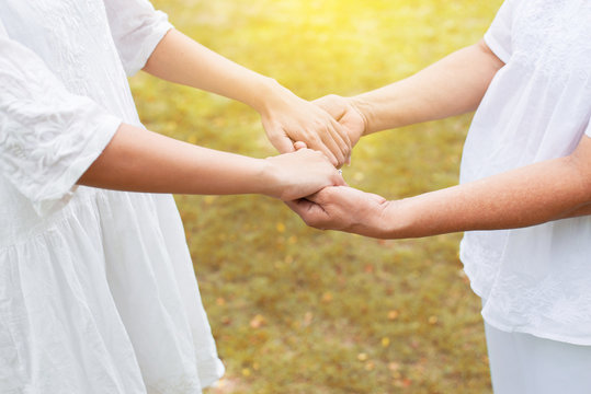 Hand of asian woman holding elderly hands while walking at outdoor,Ederly taking care concept