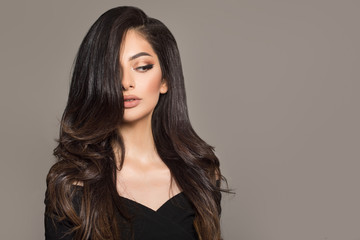 Brunette woman with long curly beautiful hair.