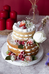 White cake Decorated with flower and berries. For celebrate party weddings, birthdays and events.