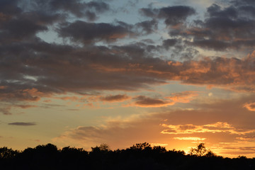 Fototapeta na wymiar Beautiful sunset sky with dramatic light. Cloudscape in summer evening.