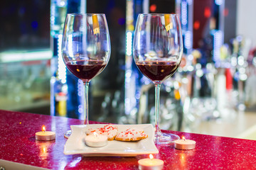 two glasses of wine and heart-shaped cookies. Valentine's Day