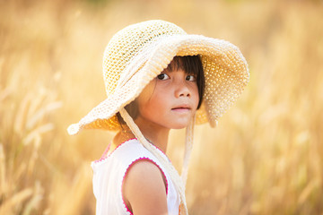 Asian girl in white dress and hat in the field, Female kid in the grass field, Little girl wearing dress and hat 