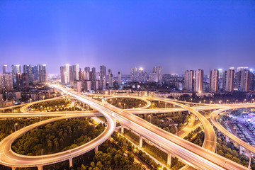 urban overpass at dusk, modern city skyline and traffic background.Wuhan, the largest transportation and economic hub city in central China.