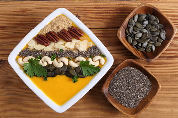 Pumpkin smoothie in a white bowl.