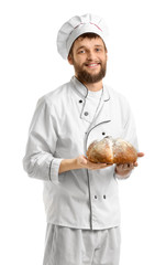 Young baker with fresh bread on white background