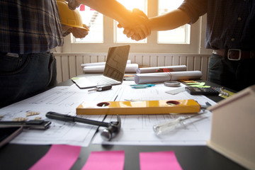 Concept Agreement between the employer and architect Nick and desk of Architectural project in construction site or office building with mining light