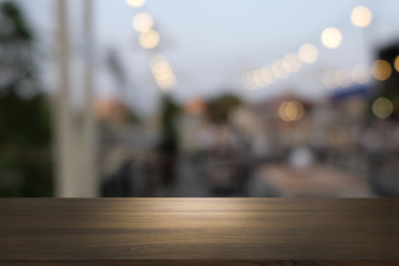Empty dark wooden table in front of abstract blurred bokeh background of restaurant . can be used for display or montage your products.Mock up for space.