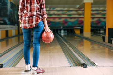 Woman playing bowling in club