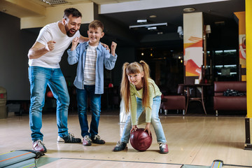 Family playing bowling in club