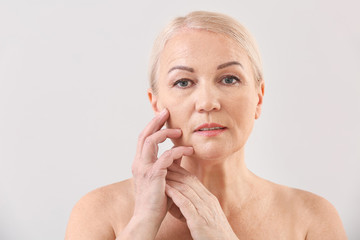 Mature woman on light background