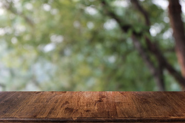 Empty dark wooden table in front of abstract blurred bokeh background of restaurant . can be used for display or montage your products.Mock up for space.