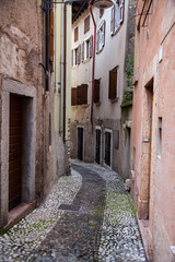 Fototapeta na wymiar Small town narrow street view with colorful houses in Malcesine