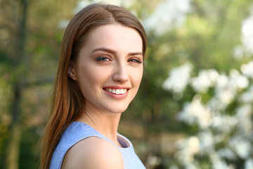 Portrait of beautiful young woman outdoors