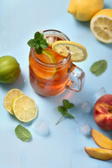 Iced tea with lemons, limes and mint with ice cubes, summer refreshment drink