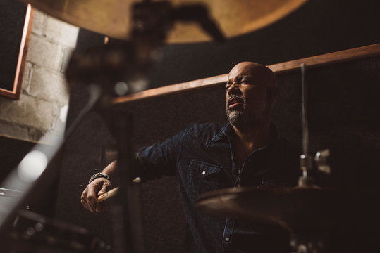 man playing drums indoor studio