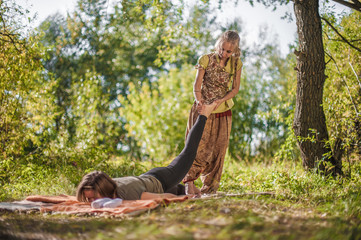 Massage and aromatherapy women on the ground with a healer.
