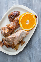 baked meat with orange on white dish